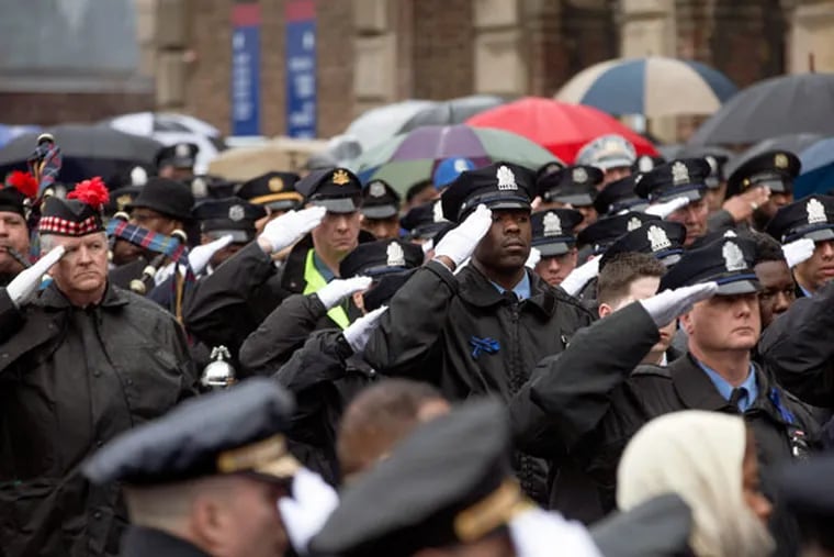 Thousands pay respect to fallen Officer Robert Wilson III at his funeral at the Palestra on Saturday, March 14, 2015. ( DAVID SWANSON / Staff Photographer )