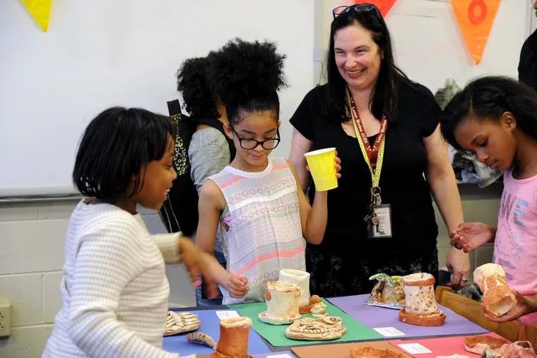Teacher Patty Smith paid to bring a ceramics program to Anderson Elementary, which has no art teacher. Pupils include (from left) Tatiyana Parks, Siyani Taylor, and Simaya Williams.