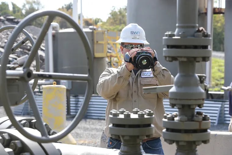 A Southwest Energy technician uses a special infrared camera to detect gas leaks at a well site in Northeastern Pennsylvania.