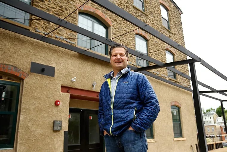 Jason Dempsey, of DP Partners, stands in front of 410 Shurs Lane in Manayunk, where he and his business partner, Marc Pellicciota, are developing 38 new apartments.