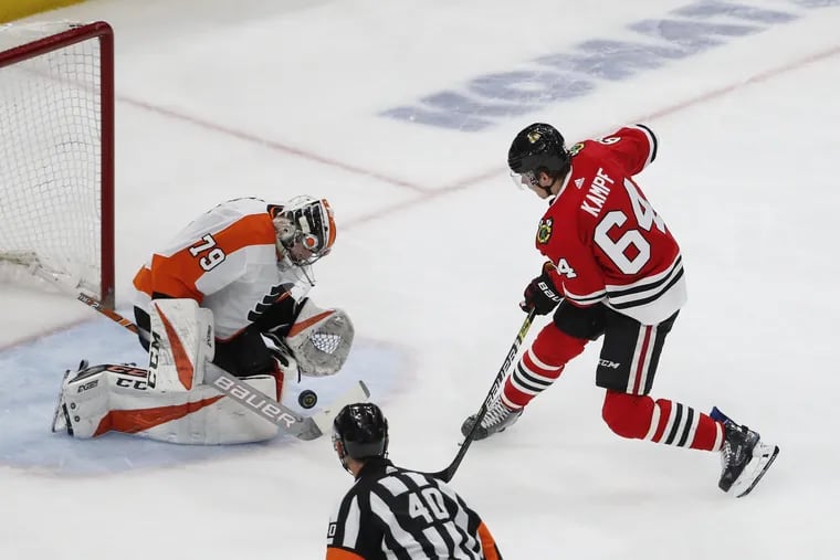 Carter Hart makes a save during the first period of an NHL hockey game Thursday, March 21, 2019, in Chicago. (AP Photo/Kamil Krzaczynski)