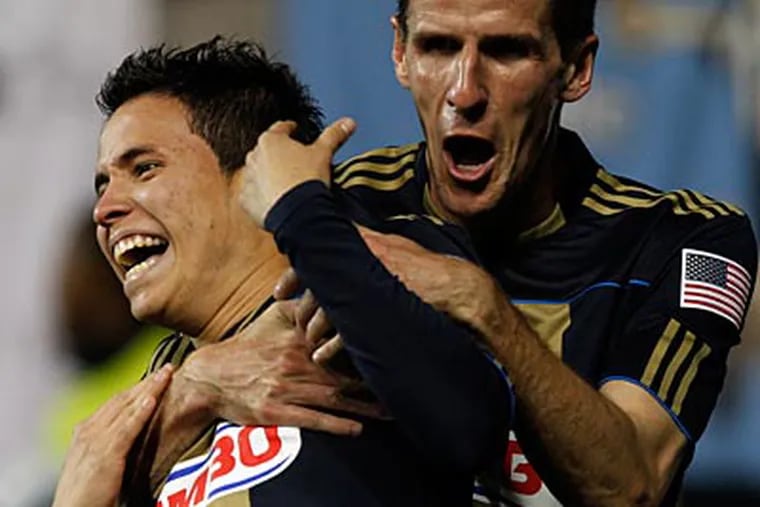 Sebastien Le Toux congratulates Roger Torres after scoring during the Union's 1-0 victory. (Laurence Kesterson/Staff Photographer)