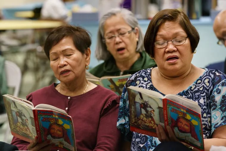 (Left to Right) Reme Cargado, Evangeline Kalugdan (back center), and Violy David sing at the Social Hall of Our Lady of Hope Catholic Parish in North Philadelphia. Filipino Catholics celebrate Good Friday by spending all day, from dawn to till dusk, singing a Tagalog religious text about the life of Jesus Christ.