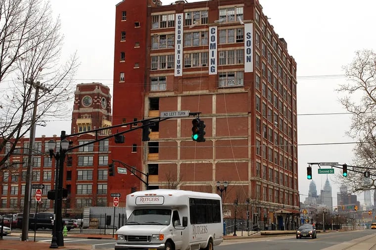 The developer of the Victor Building apartments (far left) is accused in a lawsuit of unjustly using his claim to the Radio Lofts development site (right) as leverage against Camden officials, among other allegations.