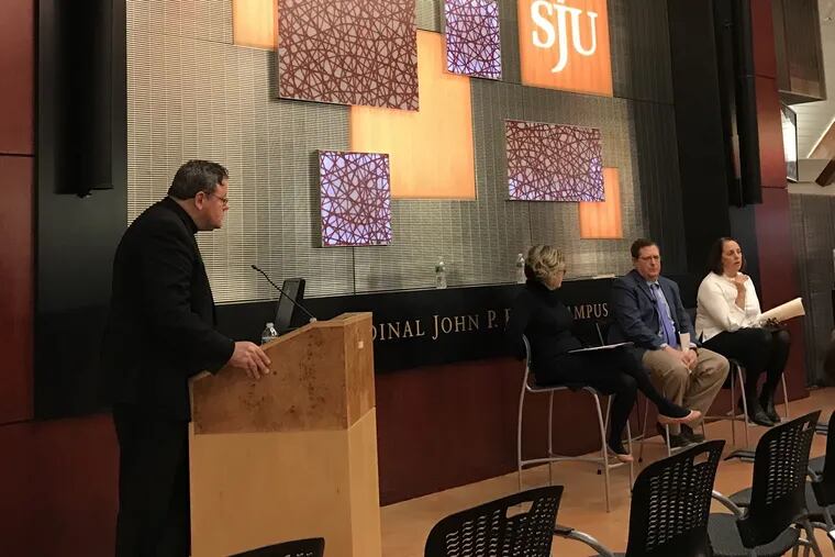 The Rev. Dan Joyce, left, of St. Joseph's University, moderates a panel discussion about the Pennsylvania grand jury report into clergy abuse on Wednesday, February 6, 2019. Also present were (L to R) Kathleen Sparrows Cummings of Notre Dame University, Philadelphia attorney Henry Hockheimer, and Main Line trauma therapist Cara Tripodi.