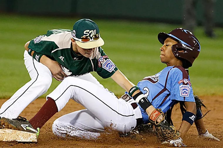 Philadelphia's Mo'ne Davis is safe at second as the ball falls out of the glove of Pearland second baseman Bryce Laird. (Gene J. Puskar/AP)