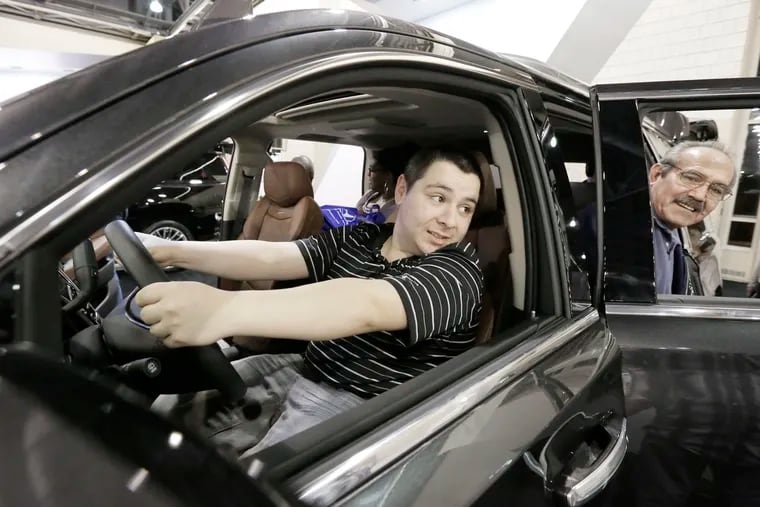 The Philadelphia Auto Show gives consumers a chance to check out cars without the pressure of a showroom salesperson. Here, Joe Garcia of Brookhaven, gets behind the wheel of the Cadillac Escalade Premium at the 2015 show.