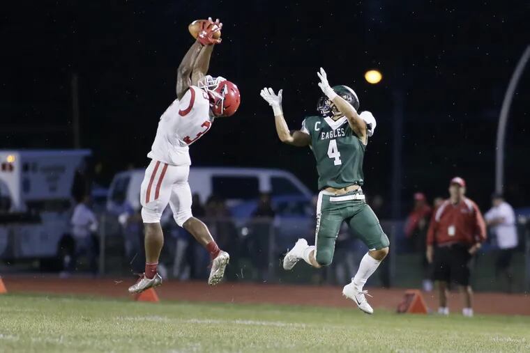 Paulsboro's # 33 Bhayshul Tuten intercepts a ball intended for West Deptford's # 4 Kenny Lim in the 2nd quarter of the Paulsboro at West Deptford HS football game on Aug. 31, 2018. Tuten ran the interception into the endzone for a touchdown and, with the extra point, gave Paulsboro a 7-0 2nd quarter lead. ELIZABETH ROBERTSON / Staff Photographer