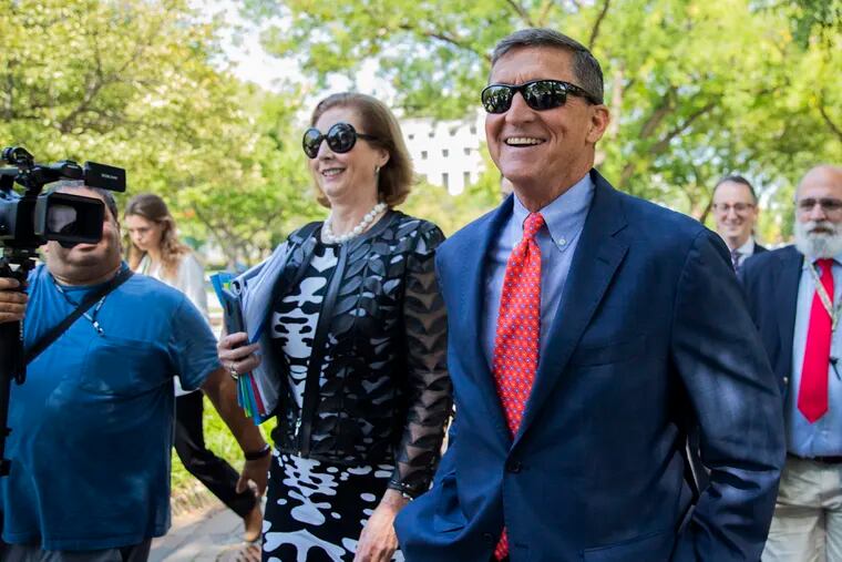 Michael Flynn, President Donald Trump's former national security adviser from Middletown, R.I., leaves federal court with his lawyer Sidney Powell, left, following a status conference in Washington. On Nov. 25, 2020, Trump pardoned Flynn despite Flynn's guilty plea to lying to the FBI about his Russia contacts.