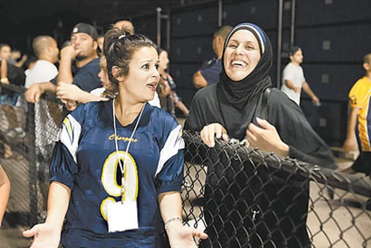 A hijab is not unusual at a high school game in Dearborn, where the coach and much of the team are Muslim. (Adam Rose / TLC)
