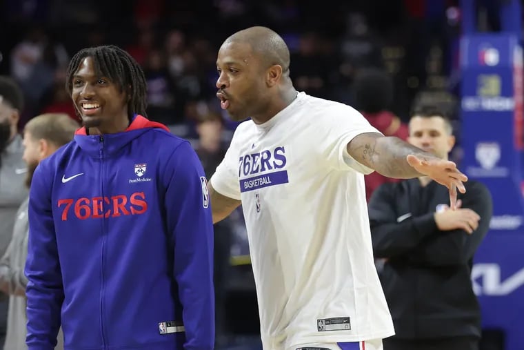 The Sixers' P.J. Tucker, right, gives Tyrese Maxey a hard time after making several 3-point shots while warming up.