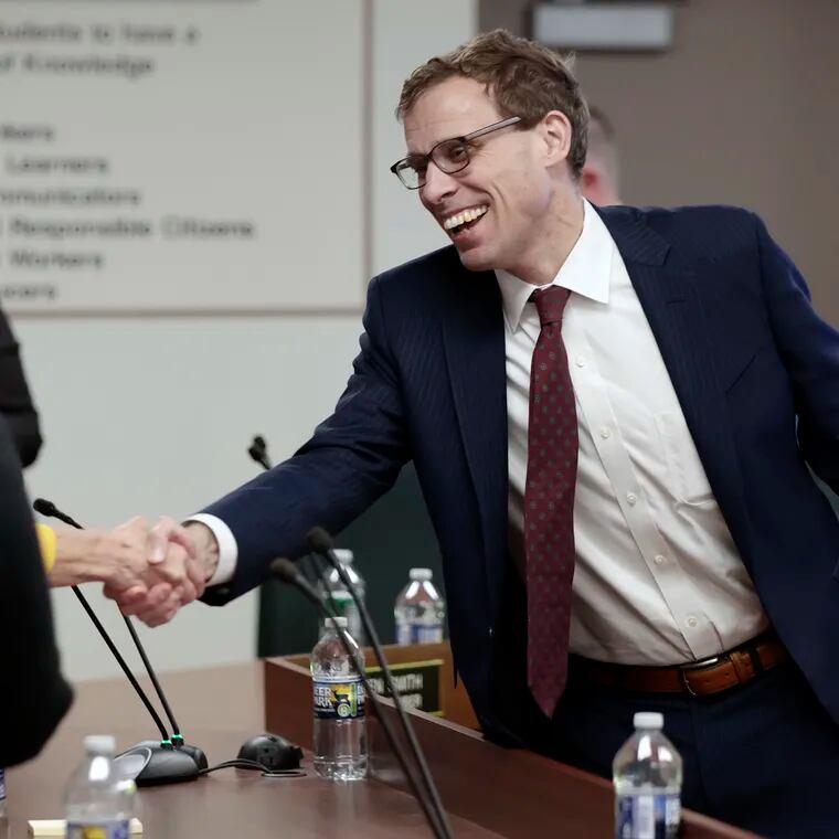 Duane Morris attorney Michael Rinaldi shakes hands with members of the Central Bucks School District board after presenting his firm's report during a special meeting at the Central Bucks School District Educational Services Building in Doylestown on April 20.