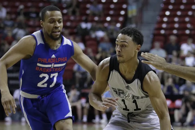 The Sixers’ Isaiah Briscoe (left) defends the San Antonio Spurs’ Bryn Forbes during NBA Summer League play.