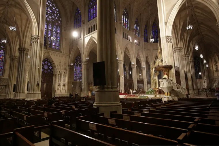 Archbishop Timothy Dolan, right, delivering his homily in April over mostly empty pews as he leads an Easter Mass at St. Patrick's Cathedral in New York.