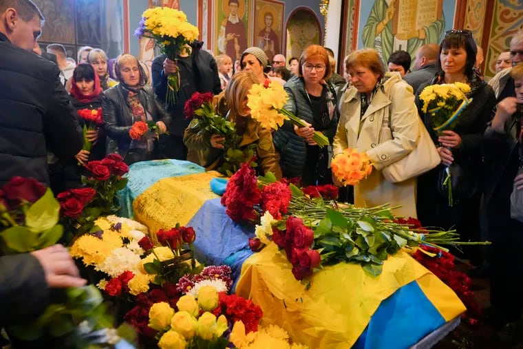 People pay their respects during the funeral ceremony for Ukrainian serviceman Ruslan Borovyk, who was killed by Russian troops in a battle in St Michael cathedral in Kyiv, Ukraine.