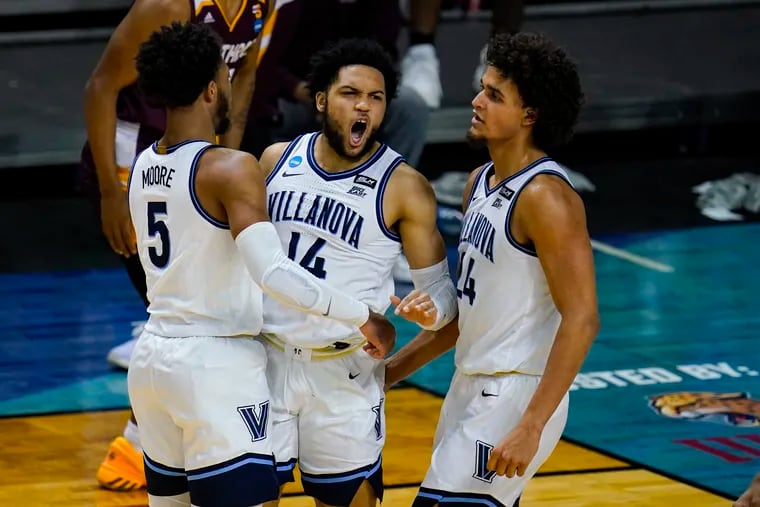 Villanova guard Caleb Daniels (14) celebrates a defensive stop with Justin Moore (5) and Jeremiah Robinson-Earl (24) in the second half of a NCAA Tournament first-round game against Winthrop at Farmers Coliseum in Indianapolis, Friday, March 19, 2021.