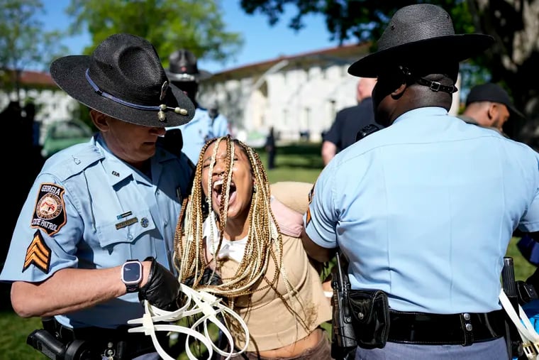 Georgia State Patrol officers detain a demonstrator on the campus of Emory University during a pro-Palestinian demonstration, Thursday, April 25, 2024, in Atlanta. (AP Photo/Mike Stewart)