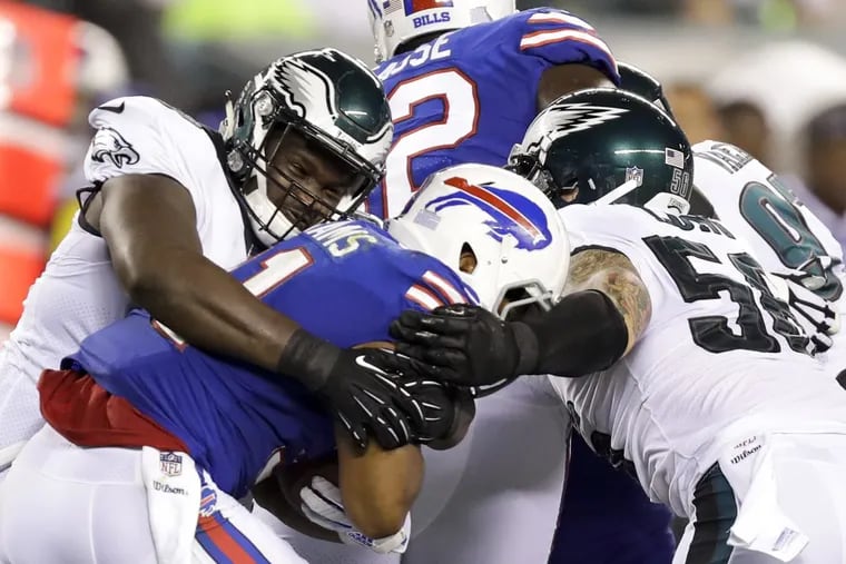 Eagles' defensive tackle Justin Hamilton (left) and defensive end Chris Long (right) stop Buffalo Bills' running back Jonathan Williams during the second-quarter in a preseason game on Thursday, August 17, 2017 in Philadelphia. YONG KIM / Staff Photographer
