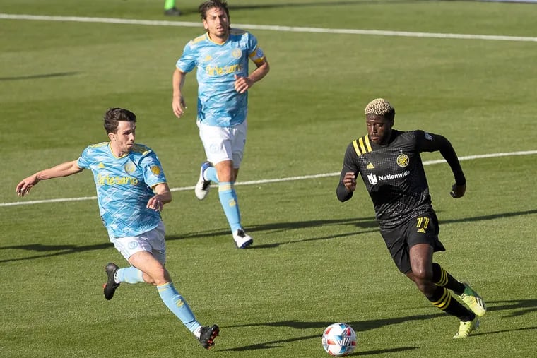 Leon Flach, left, battled for the ball against Gyasi Zardes, right, as Alejandro Bedoya looked on from behind during the Union's 0-0 tie with the Crew in Columbus on April 18.