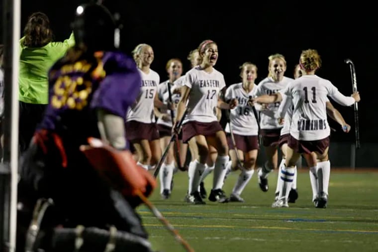 Ocean City goalie Natalie Hunter was unable to make a diving save on the penalty shot by Eastern's #11 Kelsey Mitchell (right) who is greeted by happy teammates as the score made it 9-1 in favor of Eastern during the Eastern vs. Ocean City H.S. Field Hockey Tournament of Champions semifinal at Hunterdon Centrall on Nov. 18,  2009.  Eastern won 9-1.  ( Elizabeth Robertson / Staff Photographer )  EDITORS NOTE::  JTOC19  113436   Eastern vs. Ocean City H.S. Field Hockey Tournament of Champions semifinal at Hunterdon Central.
