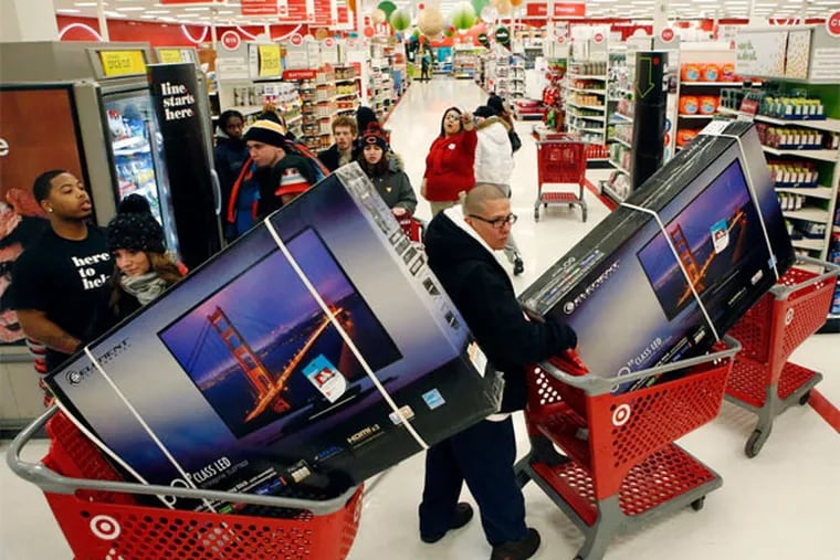 Customers head to shopping carts containing high-definition TVs at a Target store in Chicago. Retail sales rose 0.7 percent in November, the biggest gain in five months, powered by sales of autos, furniture, and electronics. (Patrick T. Fallon / Bloomberg)