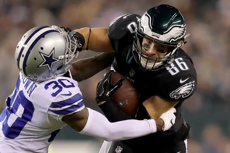 Eagles Zach Ertz, right, gives a stiff-arm to Cowboys defender Anthony Brown as the Eagles play the Dallas Cowboys at Lincoln Financial Field in Philadelphia, PA on November 11, 2018. DAVID MAIALETTI / Staff Photographer