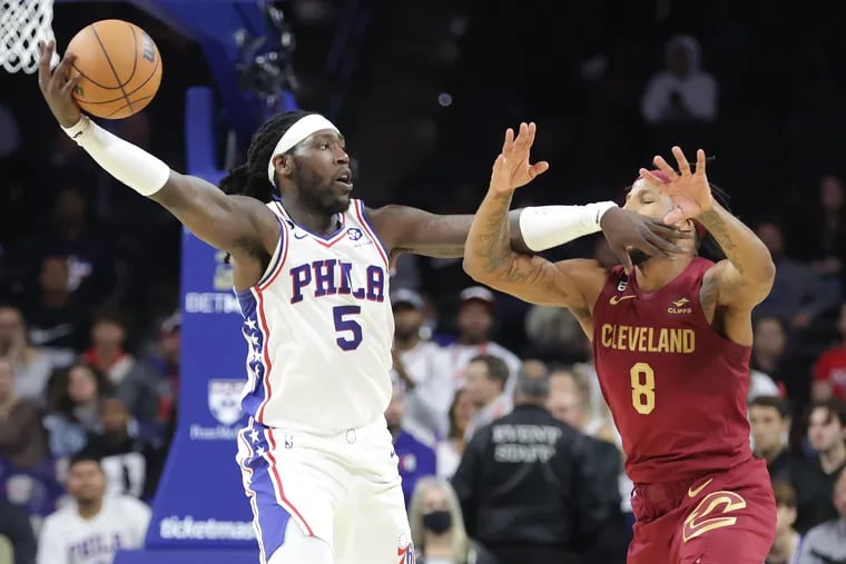 The Sixers' Montrezl Harrell catches the ball in front of the Cavaliers' Lamar Stevens during their preseason game at the Wells Fargo Center.