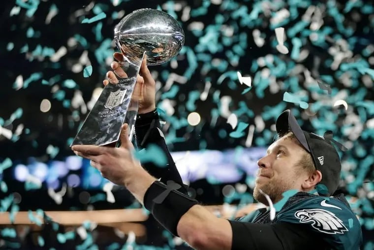 Nick Foles admires the Lombardi Trophy after he passed for 373 yards and three touchdowns in an MVP performance.