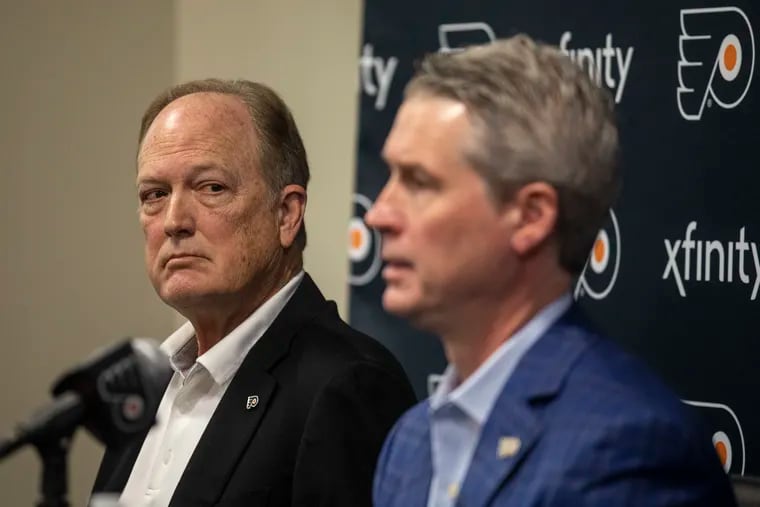 Dave Scott (left), Flyers chairman and CEO of Comcast Spectacor, listening as Flyers general manager Chuck Fletcher spoke to the media about the Flyers season in late January.
