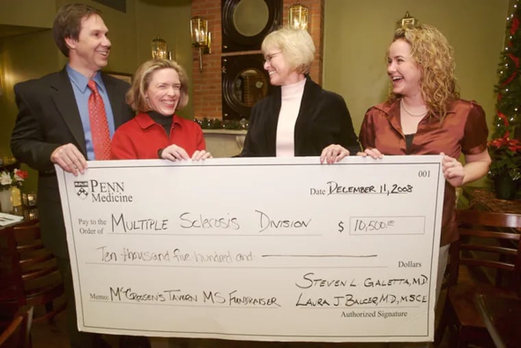Holding fundraiser check are (from left) Dr. Steven Galetta, Dr. LauraBalcer, Linda Farra and her daughter, Kristin.