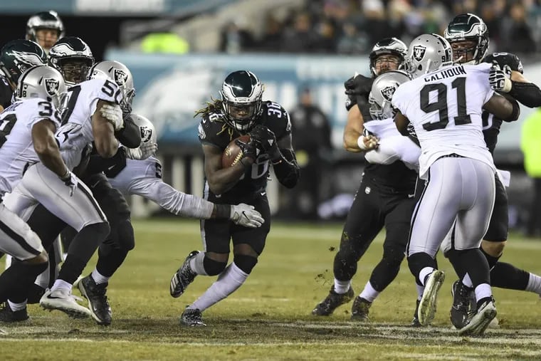 Eagles running back Jay Ajayi bursts through a hole in the Raiders defense. Is he right knee still bothering him?