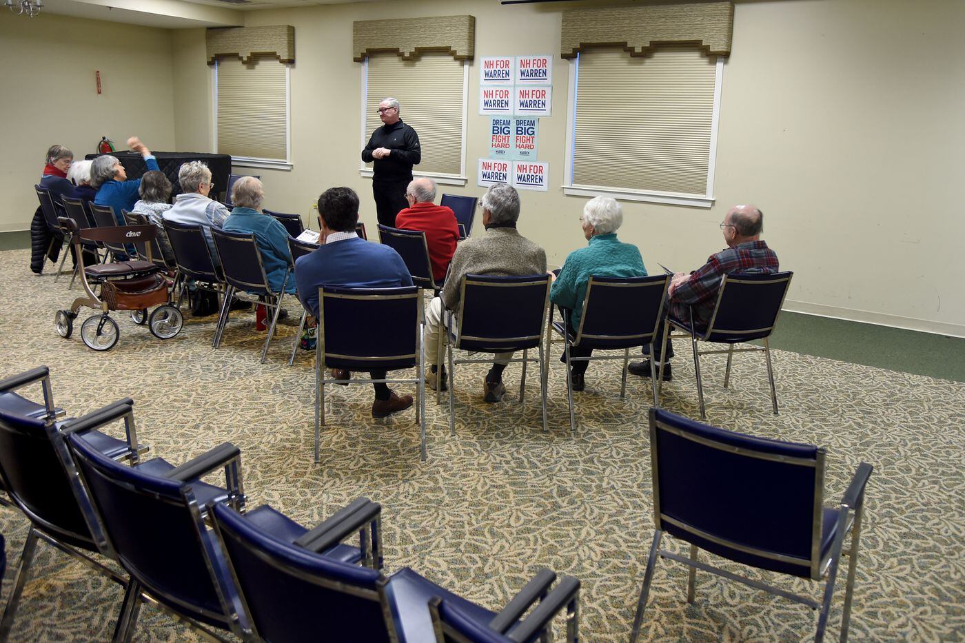 Philadelphia Mayor Jim Kenney speaks with residents at a senior enter in Concord, N.H., while campaigning for Sen. Elizabeth Warren. One voter asked him about the city's beverage tax.