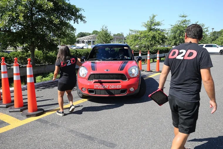 Ronit Tehrani (left) and Edward Kraftmann (right), co-owners of Driven2Drive, work with a customer at Driven2Drive in Oaks, Pa., on Wednesday. Driven2Drive is a driver's education and independent test center that offers PennDOT certified driving tests.