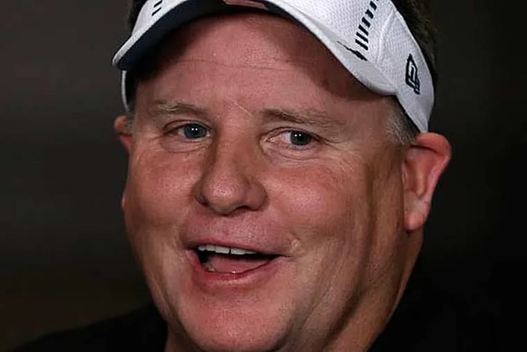 Chip Kelly wears a visor given to him to wear by a reporter during a television interview after a press conference at the team's NFL football training facility, Thursday, Jan. 17, 2013, in Philadelphia. (Matt Rourke/AP)