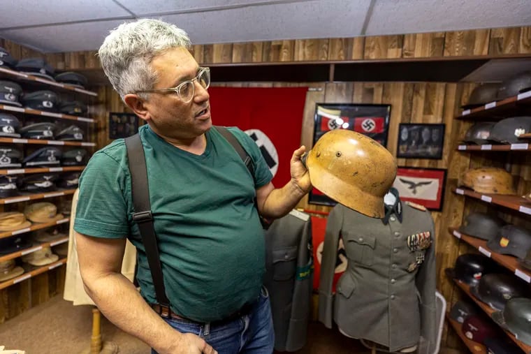 David Tabby shows one of his father's favorite items, a desert camo Model M35 Stahlhelm combat helmet that German soldiers wore in North Africa with the Afrika Corps. The family is Jewish, and not direct descendants of Holocaust survivors.