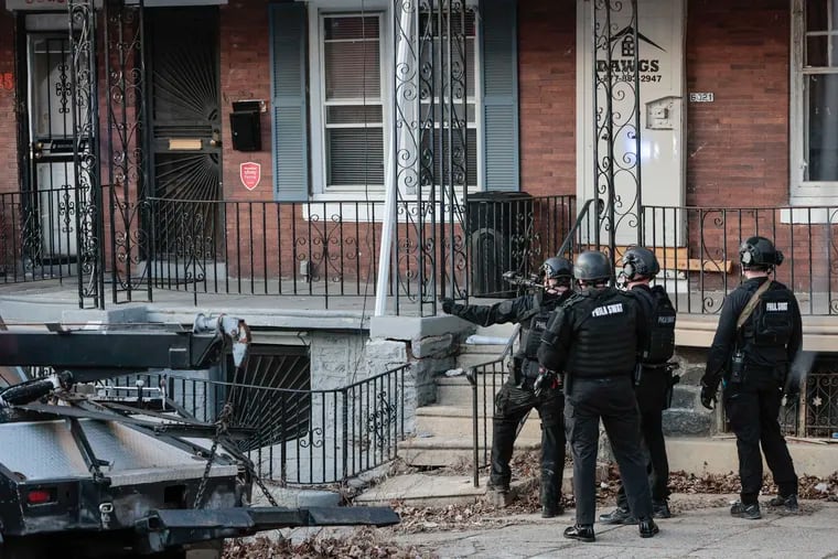 SWAT officers on the scene on 6000 block of Race street around the corner from where a 19th district police officer was hospitalized in critical but stable condition after being shot twice Wednesday afternoon during a vehicle investigation in West Philadelphia, Wednesday, February 8, 2023.