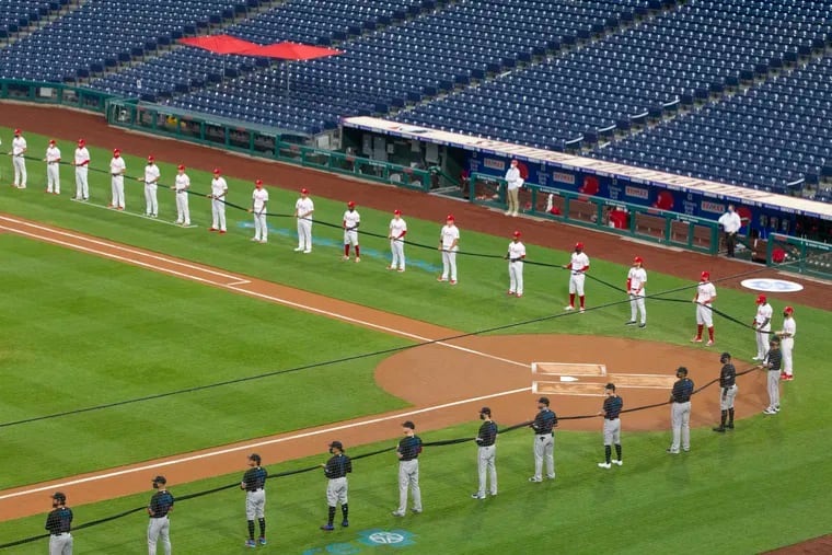 The Phillies and Marlins held up a symbolic ribbon along the first and third base lines in support of the Black Lives Matter movement, diversity and inclusion before Friday night's opener at Citizens Bank Park.