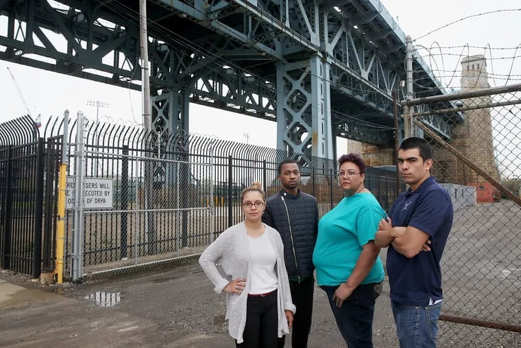 From left, North Camden residents Felisha Reyes Morton, Rudy M. Underdue, Jackie Santiago and Luis Gaitan in a file photo outside the F.W. Winter building in Camden near the site proposed for a 16-story digital billboard by Interstate Outdoor Advertising. TIM TAI/Staff