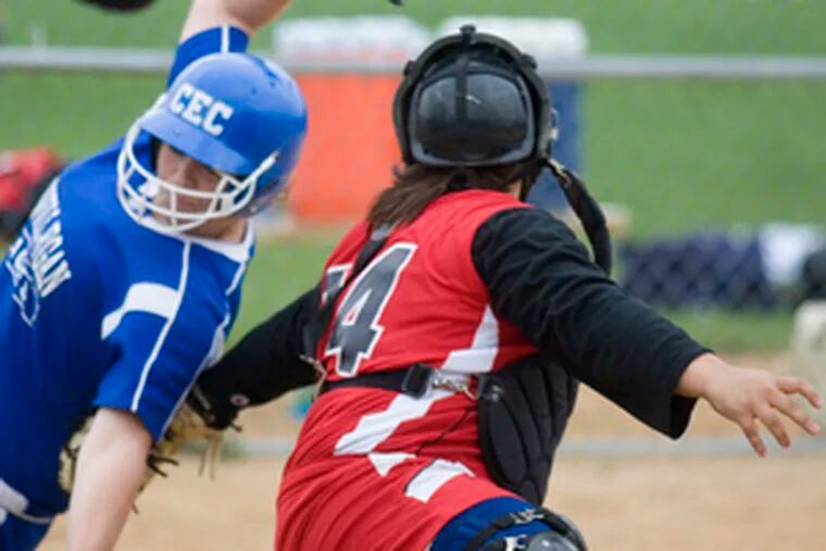 Archbishop Ryan catcher Danielle Sweeney reaches behind her to tag out Conwell-Egan&#0039;s Kaitlyn Chase at home plate in the third inning. Conwell-Egan prevailed over Ryan, 4-2, in a 12-inning marathon.