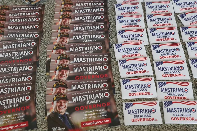 Campaign items for Pa. State Sen. Doug Mastriano, Republican nominee for governor, sit outside of Gatsby's Bar & Grill where he spoke to supporters in Aston, Pa. on Aug. 24.