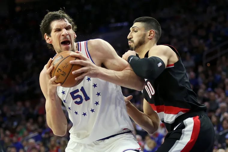 The Portland Trail Blazers' Enes Kanter (00) defends against the Sixers' Boban Marjanovic (51) during a game at the Wells Fargo Center in South Philadelphia on Saturday, Feb. 23, 2019.