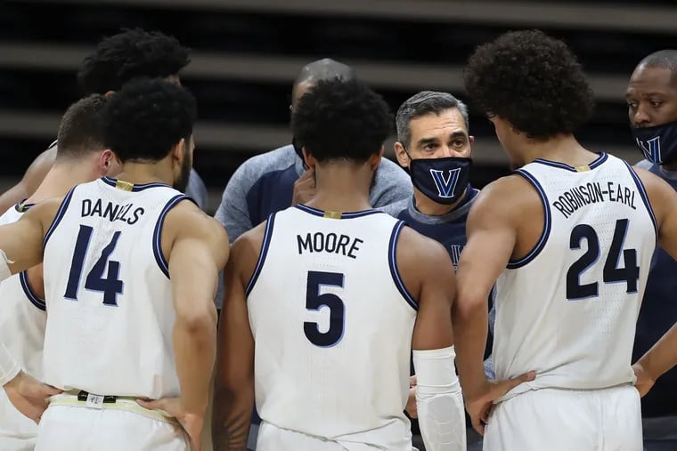 Coach Jay Wright of Villanova huddles his team during their game against Marquette on Feb. 10 at the Finneran Pavilion.