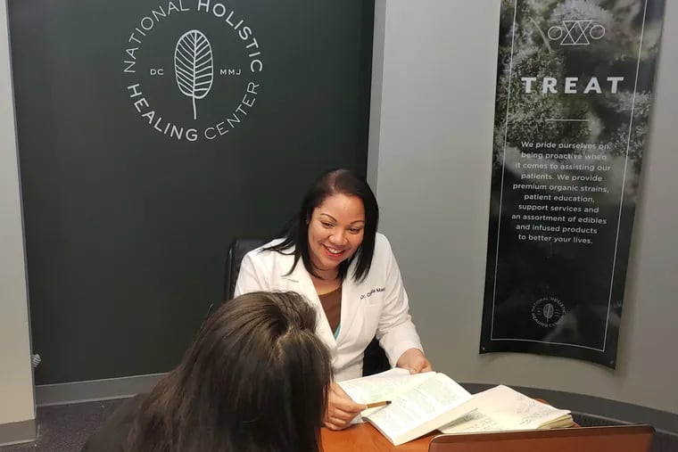 Dr. Chanda Macias consults with a patient at the National Holistic Healing Center in Washington, D.C., which also offers medicinal marijuana care for patients from Pennsylvania.