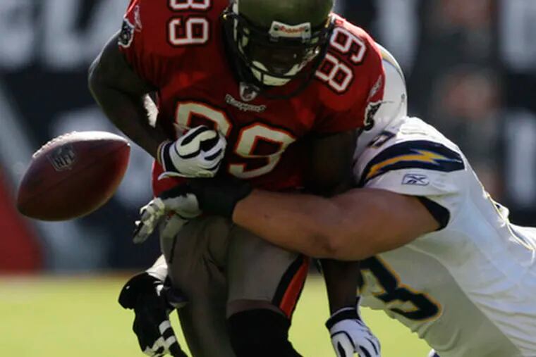 Tampa Bay wide receiver Antonio Bryant (89) fumbles after getting hit by San Diego defensive end Luis Castillo. The Chargers recovered the football and went on to win, 41-24.