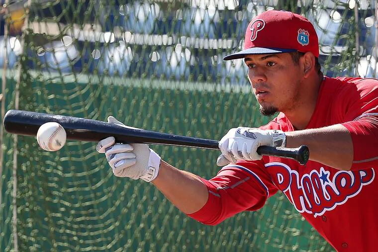 Jorge Alfaro practices bunting before the Phillies play the University of Tampa.