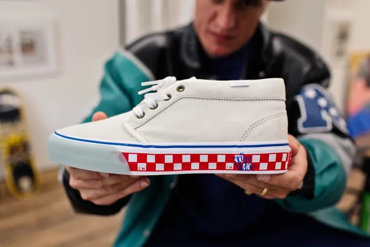 Veteran skateboarder Jimmy Gorecki holds a shoe he designed for a collaboration with Vans that is inspired by Philly.
