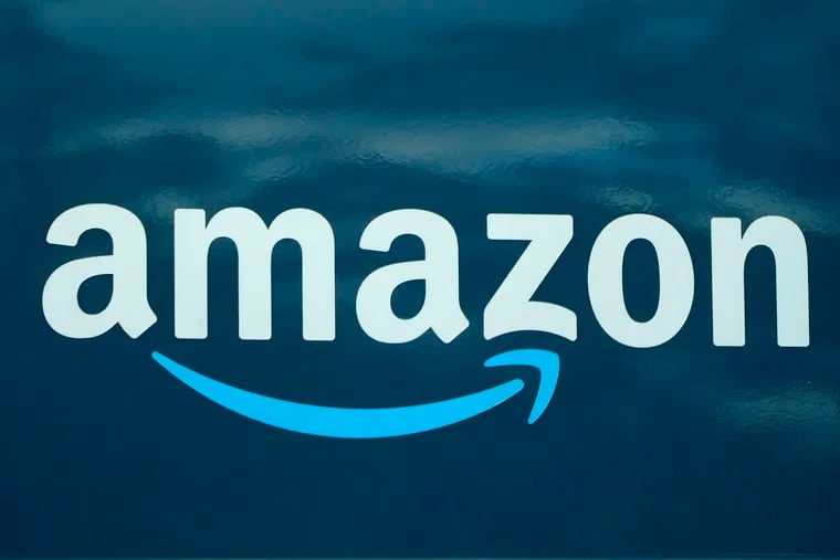 n Amazon logo appears on an Amazon delivery van in Boston.