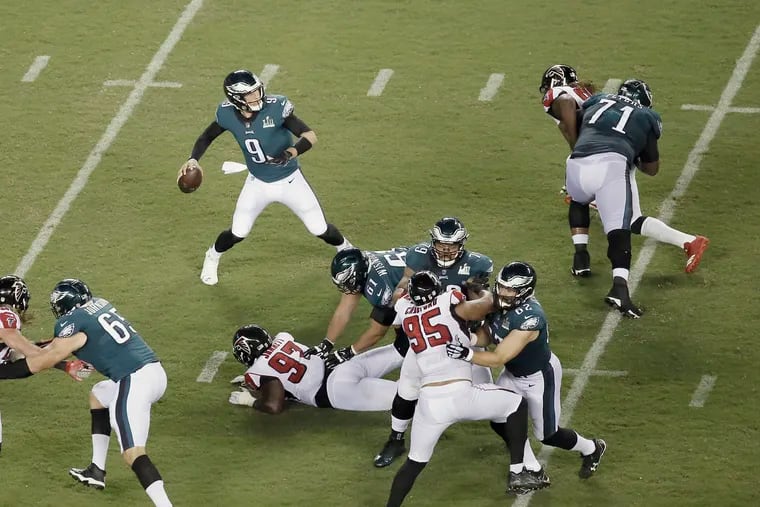 The Eagles offensive line holds off Atlanta long enough so that quarterback Nick Foles can get a pass away during the second half of the Atlanta Falcons at Phila. Eagles NFL game at Lincoln Financial Field in Philadelphia, Pa. on September 6, 2018, ELIZABETH ROBERTSON / Staff Photographer