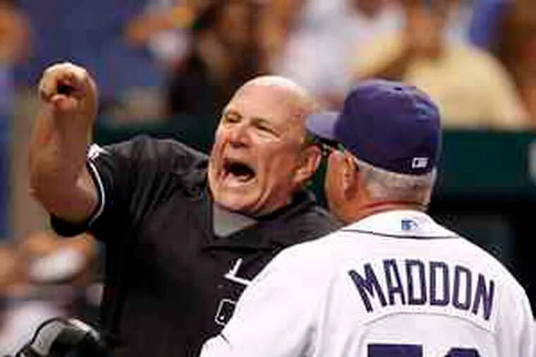 Plate umpire Bob Davidson emphatically ejects Rays manager Joe Maddon for arguing balls and strikes in the fifth inning of a 2-0 loss to the visiting Boston Red Sox.