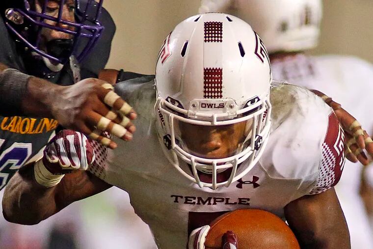 Temple running back Jahad Thomas breaks away from East Carolina's Demetri McGill in the Owls' 24-14 comeback victory.